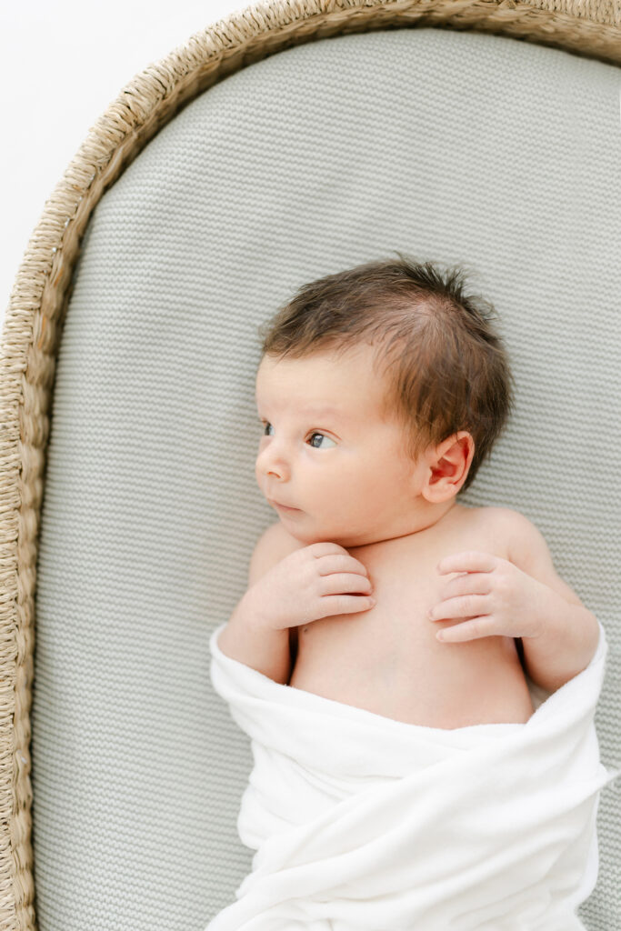 a newborn relaxes in a basket